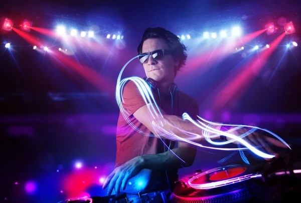 Disc jockey playing music with light beam effects on stage — Stock Photo, Image