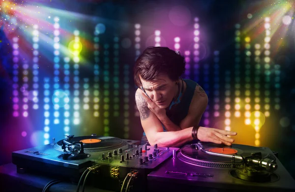 Dj playing songs in a disco with light show — Stock Photo, Image