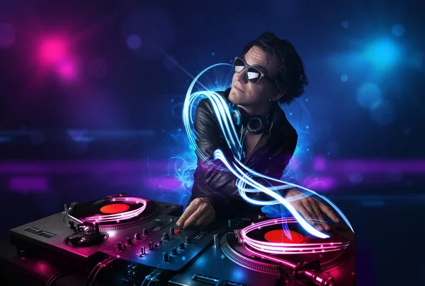 Disc jockey playing music with electro light effects and lights — Stock Photo, Image