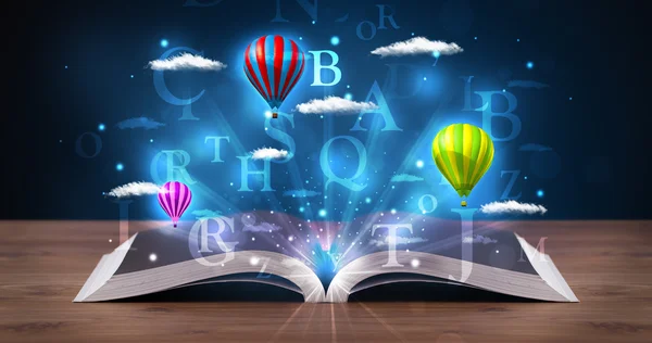 Open book with glowing fantasy abstract clouds and balloons — Stock Photo, Image