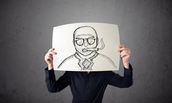 Businessman holding a cardboard with a smoking man on it in fron — Stock Photo, Image