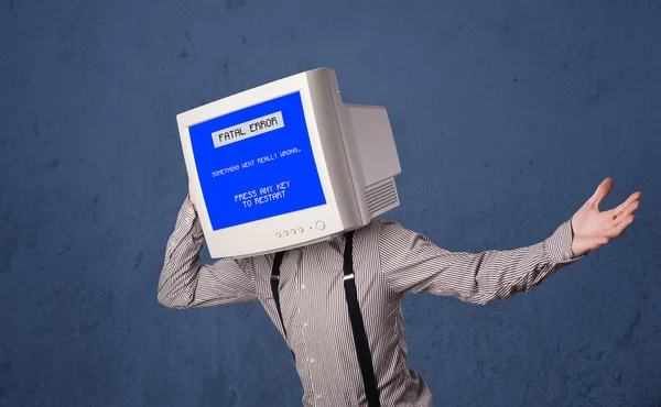 Person with a monitor head and fatal error blue screen on the di — Stock Photo, Image