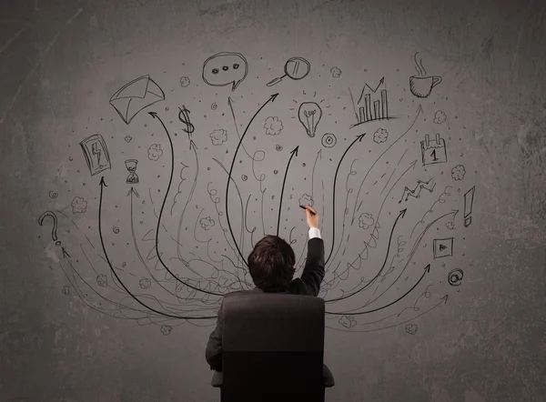 Businessman in front of a chalkboard deciding with arrows and si — Stock Photo, Image