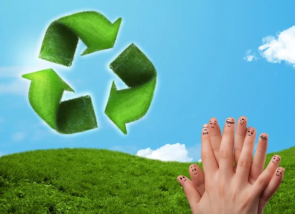 Happy smiley fingers looking at green leaf recycle sign — Stock Photo, Image