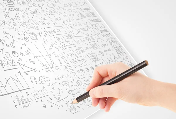 Human hand sketching ideas on a white paper