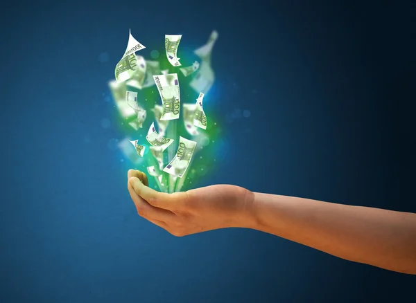Glowing money in the hand of a woman — Stock Photo, Image