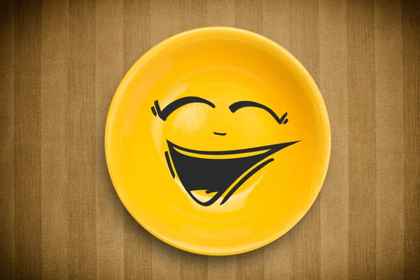 Happy smiley cartoon face on colorful dish plate — Stock Photo, Image