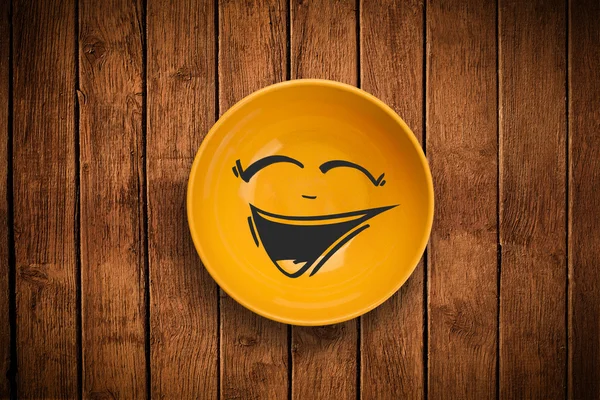 Happy smiley cartoon face on colorful dish plate — Stock Photo, Image