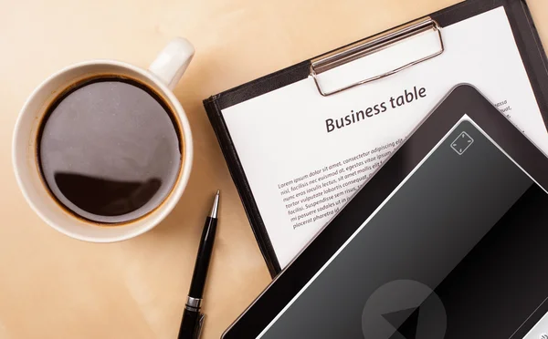 Tablet pc showing media player on screen with a cup of coffee on — Stock Photo, Image