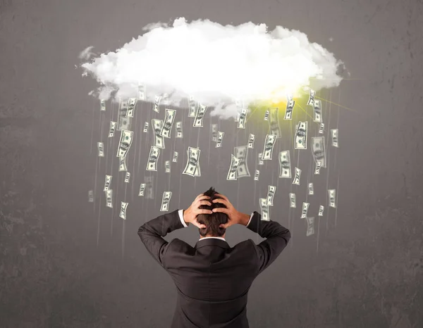 Business man in suit looking at cloud with falling money — Stock Photo, Image