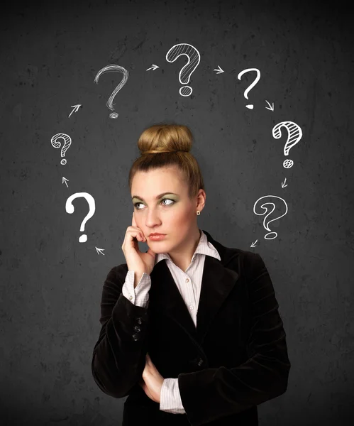 Young woman thinking with question mark circulation around her h — Stock Photo, Image