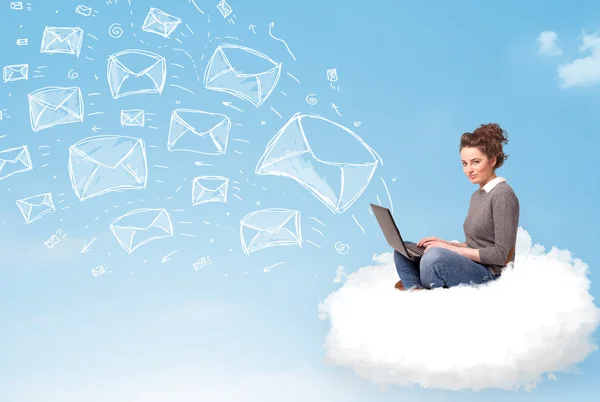 Young woman sitting in cloud with laptop — Stock Photo, Image