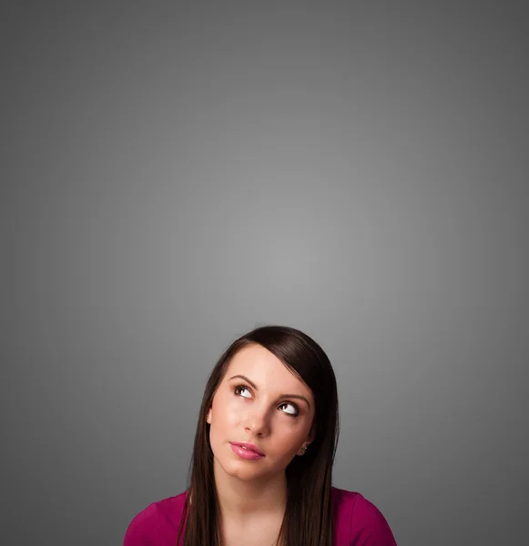 Thoughtful young woman gesturing with copy space — Stock Photo, Image