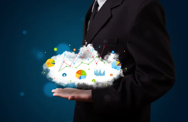 Young businessman presenting cloud with charts and graph icons a — Stock Photo, Image