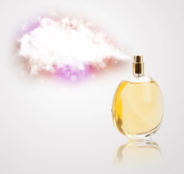 Beautiful bottle spraying colorful cloud — Stock Photo, Image