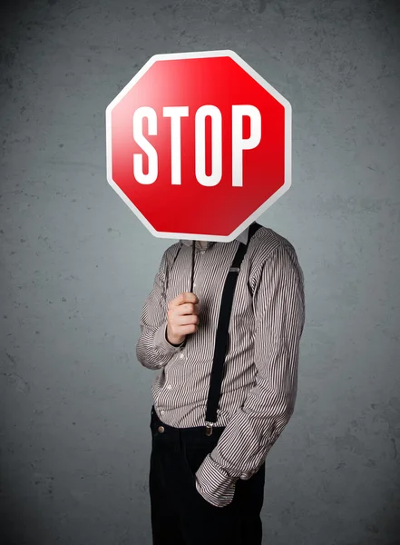 Businessman holding a stop sign — Stock Photo, Image