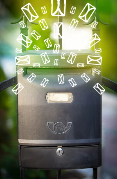 Mailbox with letter icons on glowing green background — Stock Photo, Image