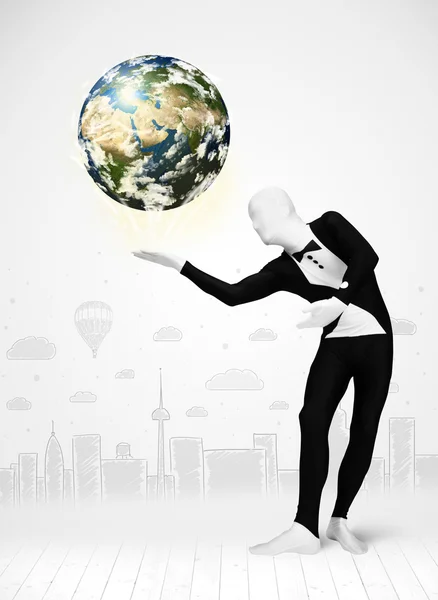 Man in full body suit holding planet earth — Stock Photo, Image