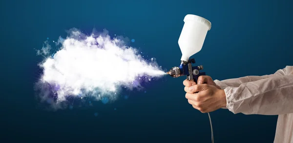 Painter with airbrush gun and white magical smoke — Stock Photo, Image