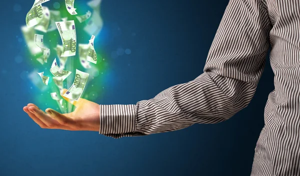 Glowing money in the hand of a businessman — Stock Photo, Image