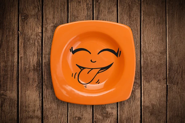 Happy smiley cartoon face on colorful dish plate — Stock Photo, Image