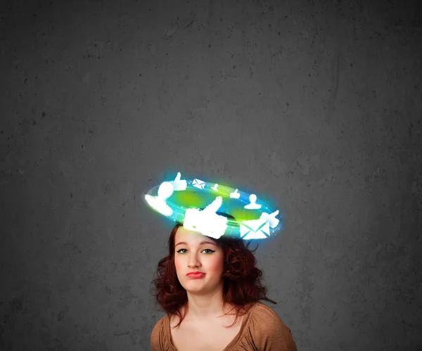 Young teenager with cloud social icons around her head — Stock Photo, Image