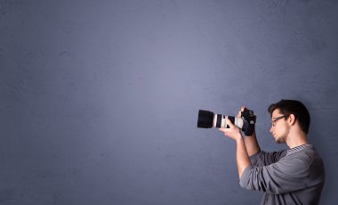 Young photographer shooting images with copyspace area clipart