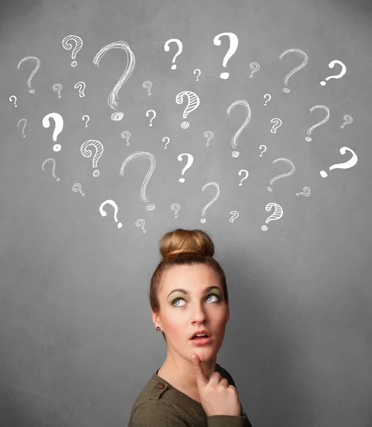 Young woman with question marks above her head — Stock Photo, Image