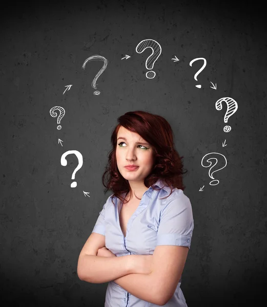 Young woman thinking with question mark circulation around her h — Stock Photo, Image