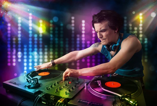 Dj playing songs in a disco with light show — Stock Photo, Image