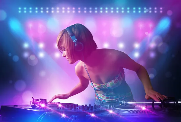 Disc jockey mixing music on turntables on stage with lights and — Stock Photo, Image