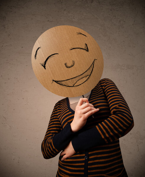 Young woman holding a smiley face board