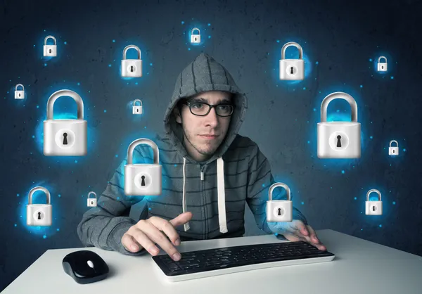 Young hacker with virtual lock symbols and icons — Stock Photo, Image