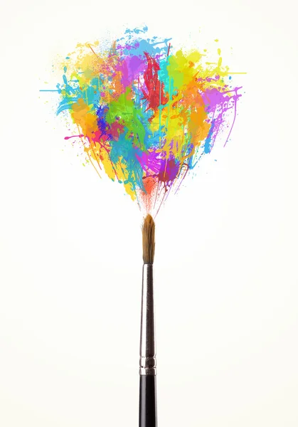 Brush close-up with colored paint splashes — Stock Photo, Image