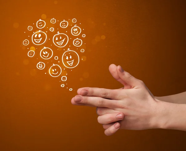 Group of happy smiley faces coming out of gun shaped hands — Stock Photo, Image