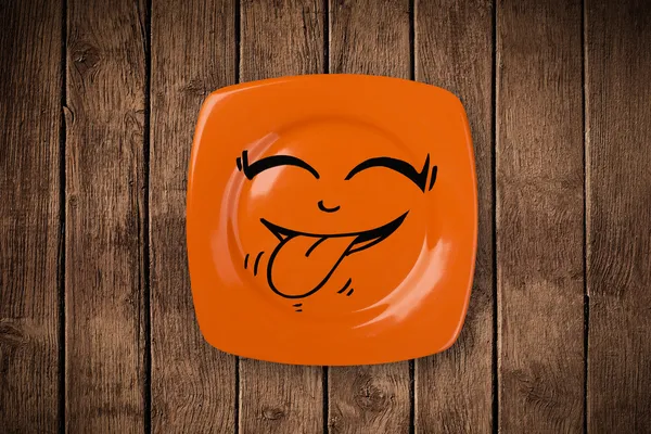 Happy smiley cartoon face on colorful dish plate — Stock Photo, Image