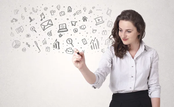 Young woman drawing and sketching icons and symbols — Stock Photo, Image