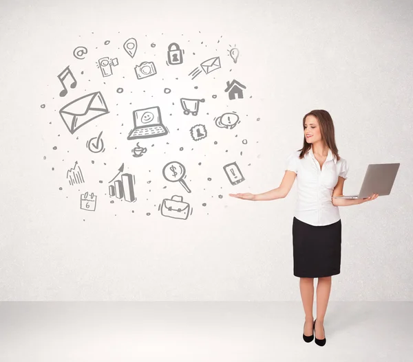 Young business woman presenting hand drawn media icons — Stock Photo, Image