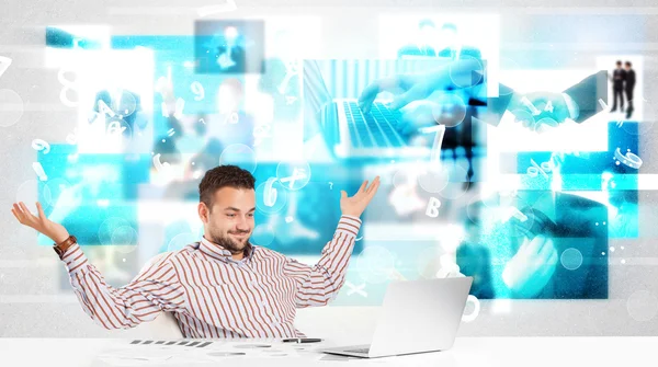 Business person at desk with modern tech images at background — Stock Photo, Image