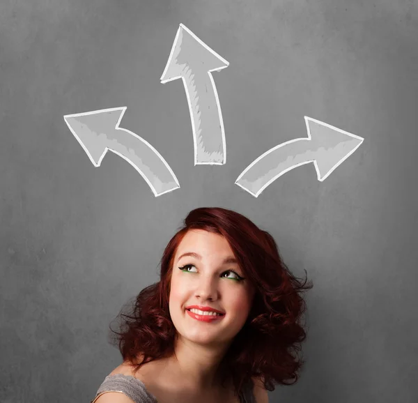 Young woman thinking with arrows above her head — Stock Photo, Image