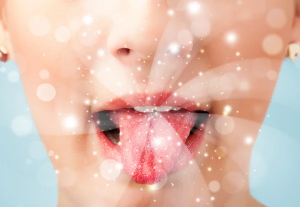 Pretty woman lips blowing abstract white lights — Stock Photo, Image