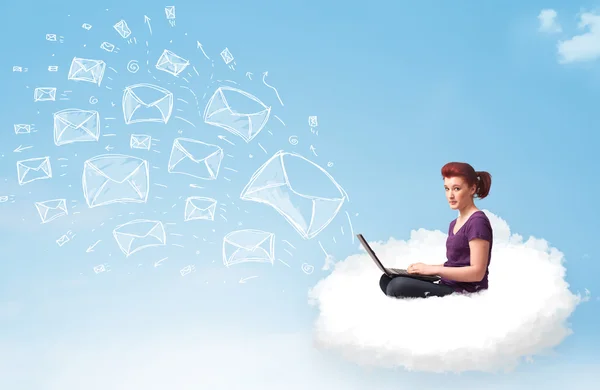 Young woman sitting in cloud with laptop — Stock Photo, Image