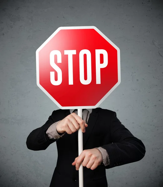 Empresario sosteniendo una señal de stop —  Fotos de Stock