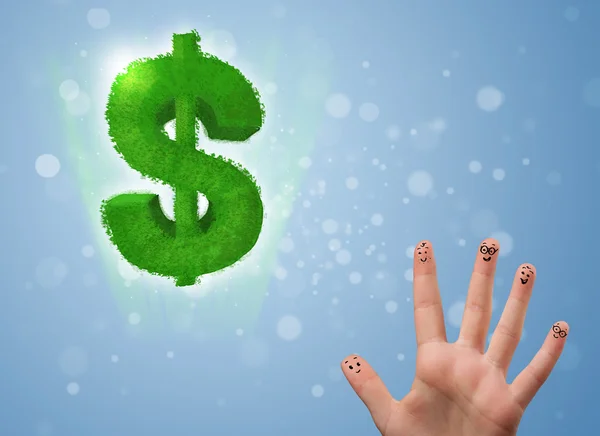 Happy smiley fingers looking at green leaf dollar sign — Stock Photo, Image