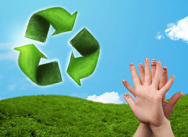 Happy smiley fingers looking at green leaf recycle sign — Stock Photo, Image