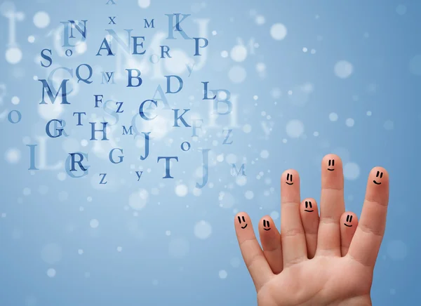 Happy smiley fingers looking at mixture of bokeh letters — Stock Photo, Image