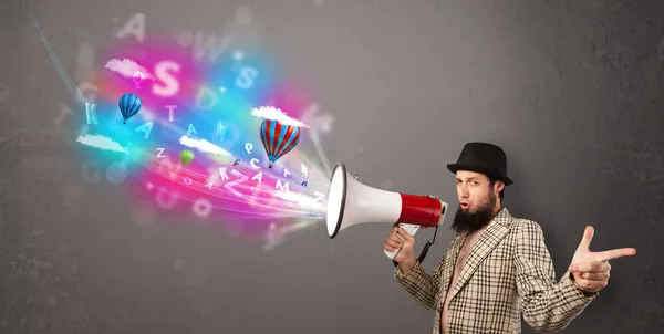 Man shouting into megaphone and abstract text and balloons come — Stock Photo, Image