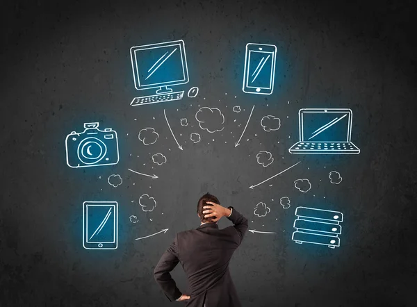 Businessman with multimedia icons over his head — Stock Photo, Image