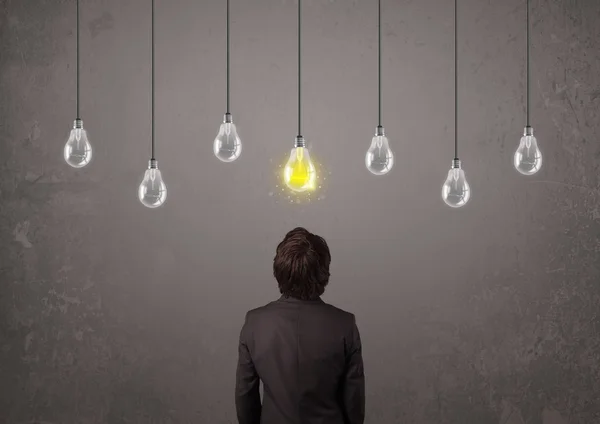 Businness guy in front of idea light bulbs concept — Stock Photo, Image