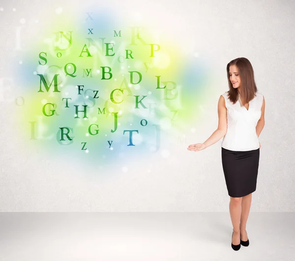 Business women with glowing letter concept — Stock Photo, Image